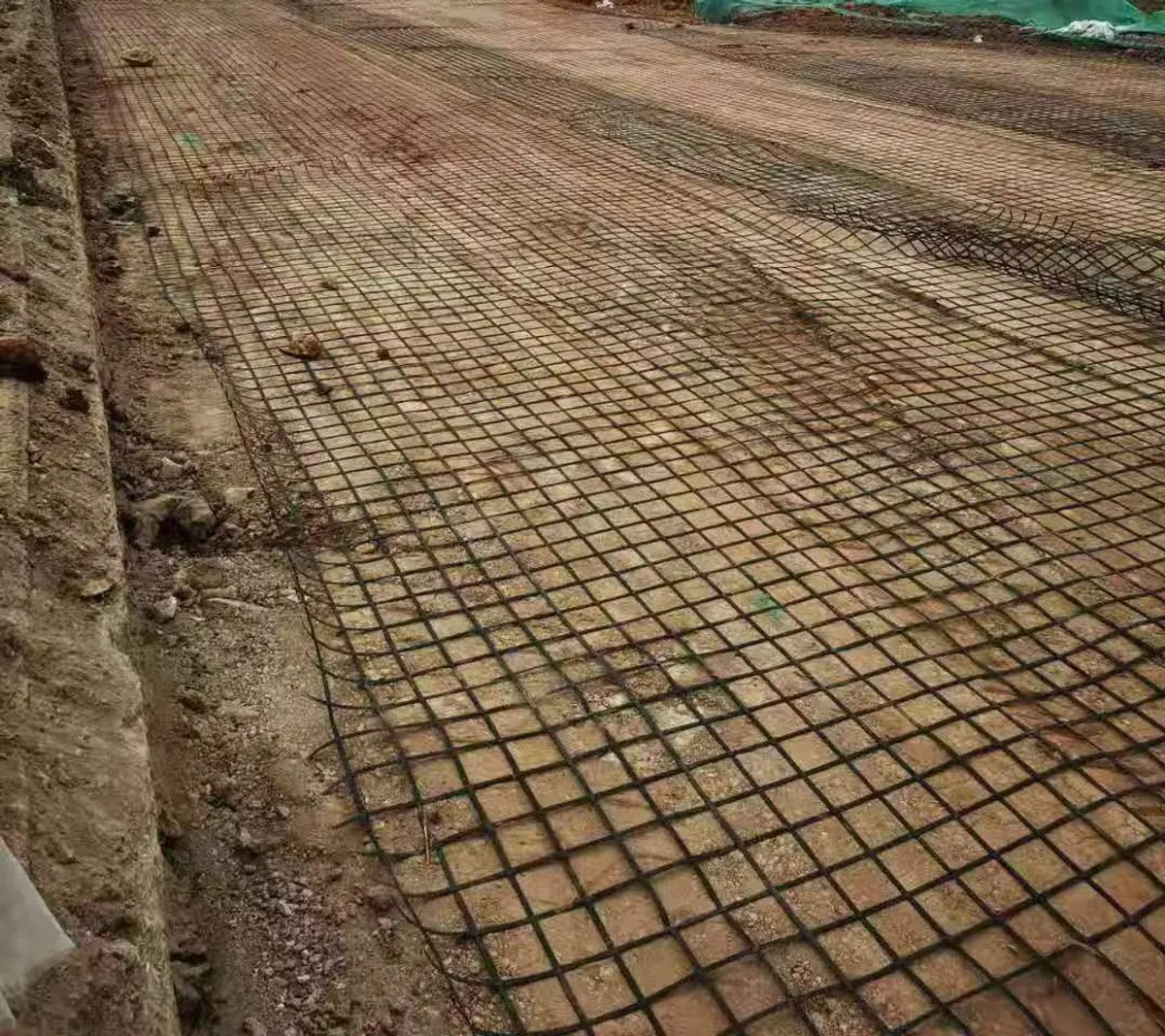 Biaxial geogrid rolled out on a prepared road formation before the aggregate base is placed