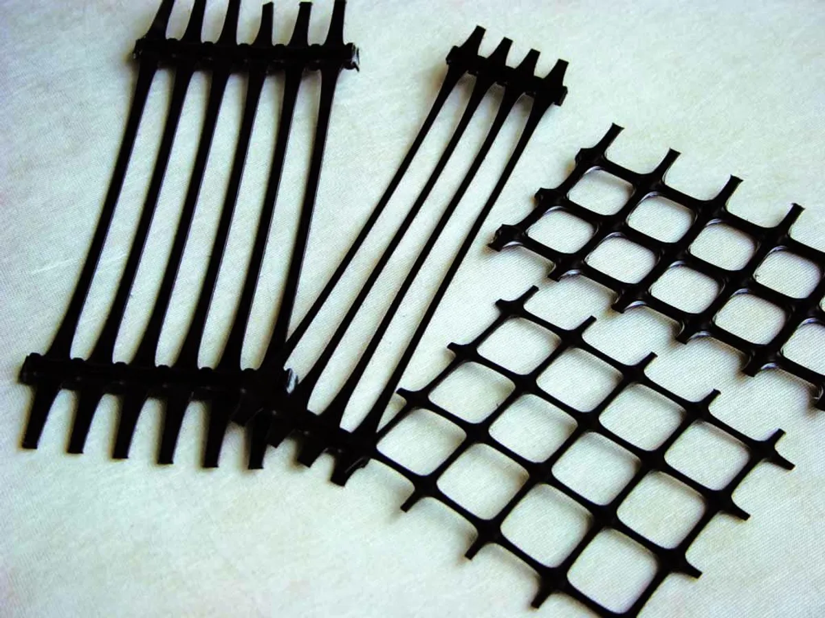 Rolls of biaxial, uniaxial and fiberglass geogrid on a construction site