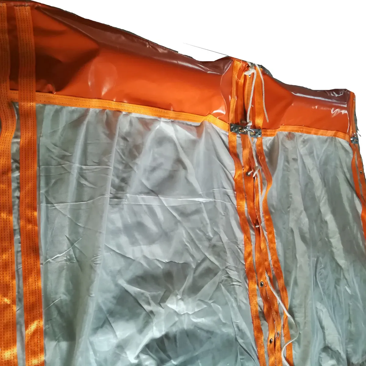 Orange flotation boom and grey skirt fabric of a SIGMA floating turbidity curtain